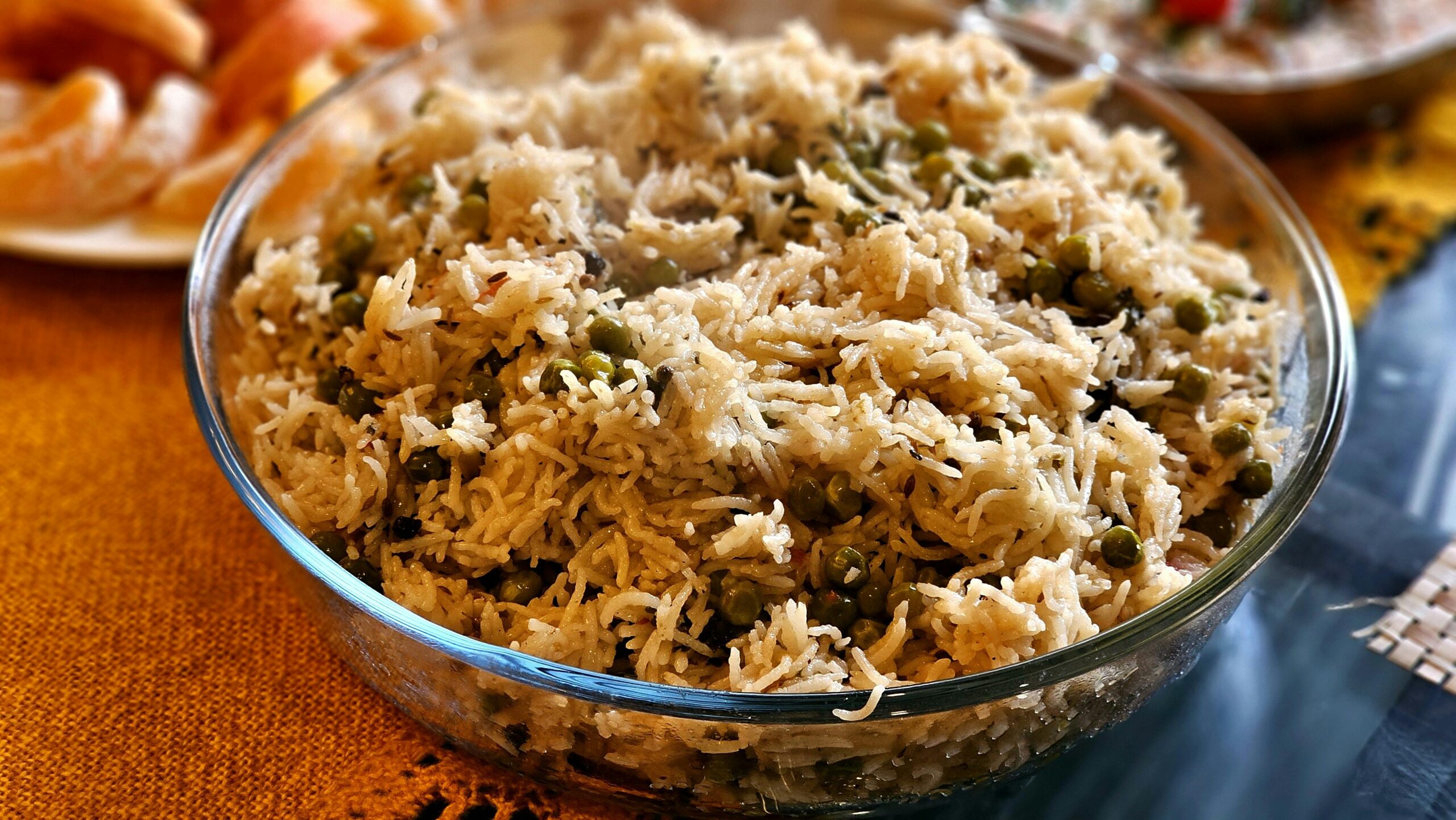 Mouthwatering pea pulao served hot in a transparent glass bowl, perfect for any meal.