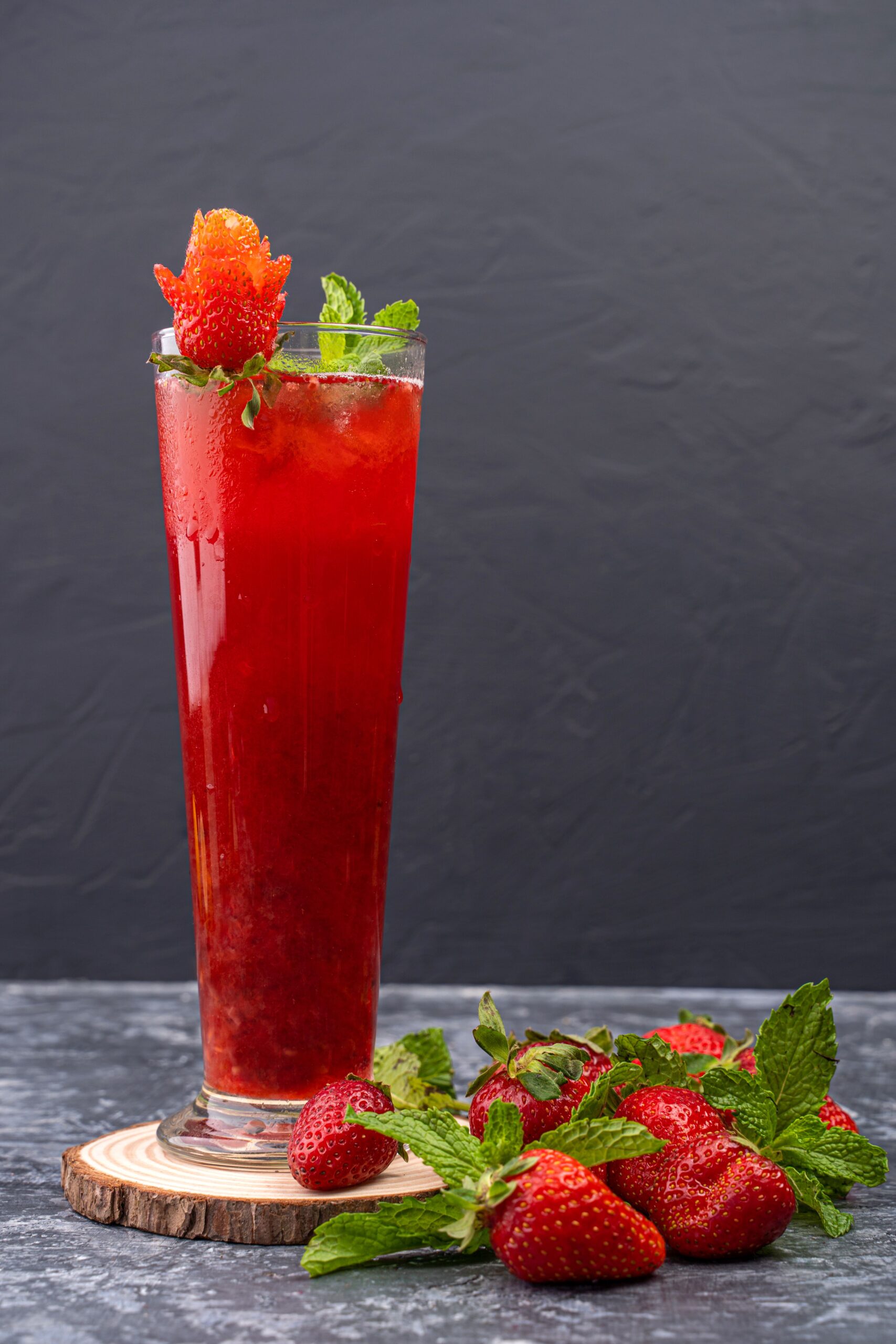 Vibrant strawberry mocktail garnished with mint leaves and fresh strawberries.