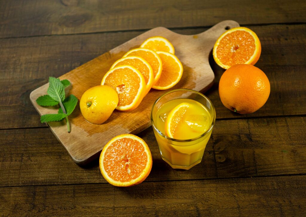 Delicious fresh orange slices with juice on a wooden cutting board, perfect for a healthy refreshment.