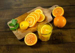 Delicious fresh orange slices with juice on a wooden cutting board, perfect for a healthy refreshment.